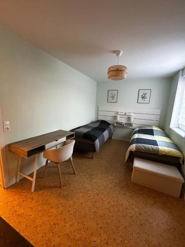 a bedroom with a bed and a desk and a couch at Lestandardgravelines in Gravelines