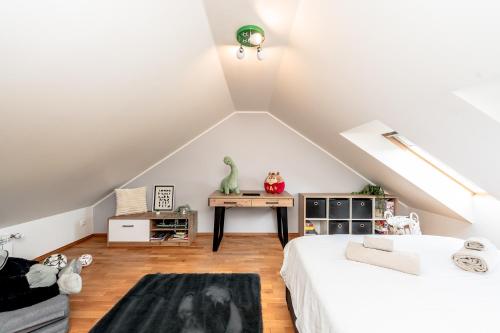 a attic bedroom with a bed and a desk at Sunset Stay Pärnu in Pärnu