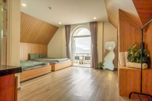 a large room with a bed and a window at Dahill 196 Dalat in Da Lat