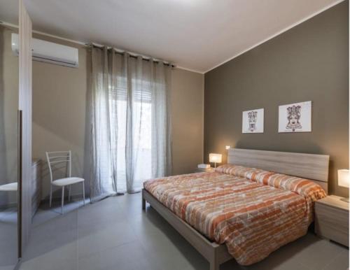 a bedroom with a large bed and a window at Aura Deluxe Apartments in Syracuse