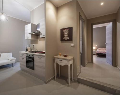 a kitchen with a counter and a table in a room at Aura Deluxe Apartments in Syracuse