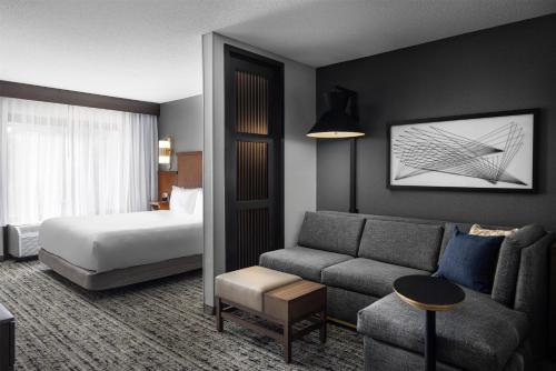 a hotel room with a bed and a couch at Hyatt Place Columbus/Dublin in Dublin