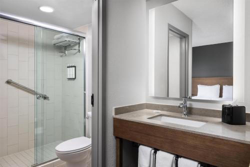 a bathroom with a toilet and a sink and a shower at Hyatt Place Colorado Springs Garden Of The Gods in Colorado Springs