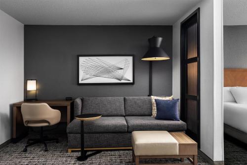 a hotel room with a couch and a bed at Hyatt Place El Paso Airport in El Paso