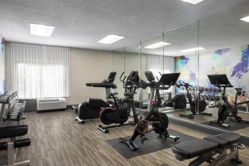 a gym with treadmills and ellipticals and mirrors at Hyatt Place El Paso Airport in El Paso