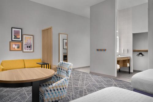 a living room with a table and a couch at Hampton Inn & Suites Roswell in Roswell