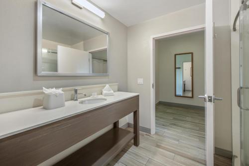a bathroom with a sink and a mirror at Hampton Inn Channel Islands Harbor in Oxnard