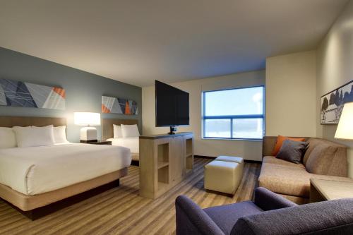 a hotel room with a bed and a tv at Hyatt House Oak Brook in Oak Brook