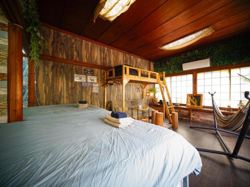 a bedroom with a bed in a wooden room at Wonderlust Inn in Kamakura