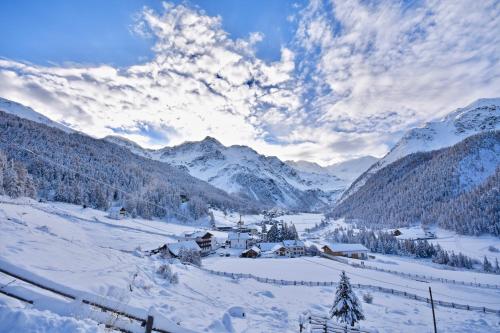 a snow covered valley with mountains in the background at Bed & Breakfast Hostel Nives in Solda