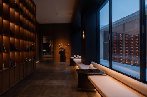 a bathroom with a row of sinks and a window at ZOLAND Resort Hotel ·Emei Mountain in Emeishan City