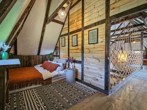 a bedroom with a bed and a wooden wall at Nooks by AdyBeca - Panoramic Nook in Şuncuiuş