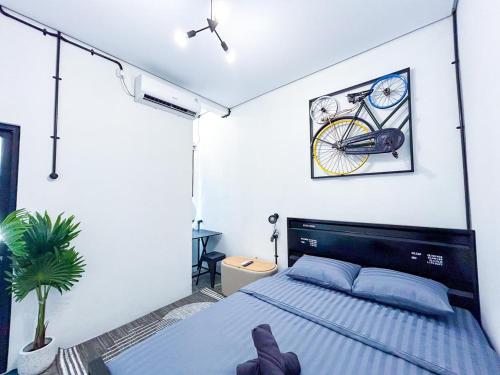 a bedroom with a bed with a bicycle on the wall at X Hostel Jogja in Timuran