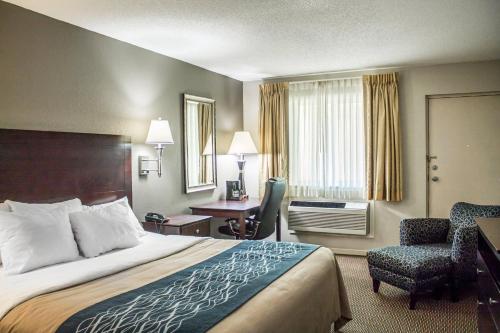 a hotel room with a bed and a desk at Comfort Inn Sandusky in Sandusky