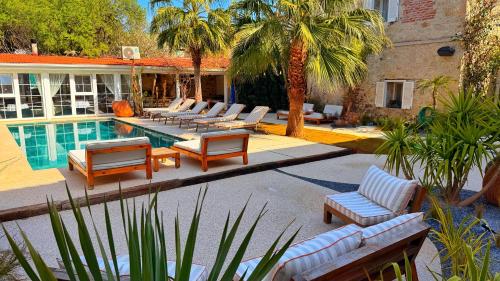 a pool with chaise lounge chairs and a swimming pool at Jardin d'Azur Alaçatı in Alaçatı