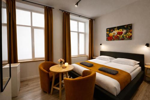 a bedroom with a large bed and a table at Apart-HOTEL GALLERY 21 in Lviv