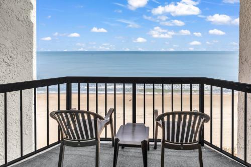 a balcony with two chairs and the beach at Compass Cove 1466 in Myrtle Beach