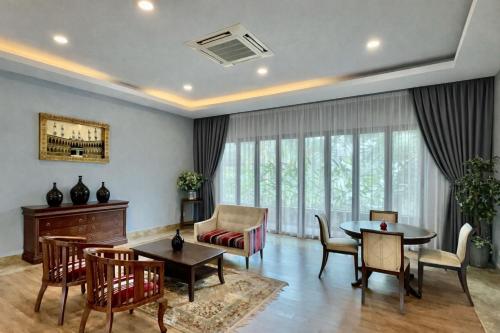 a living room with a table and chairs at Villa Alam Klang managed by Bella Vista Hotels & Resorts in Klang