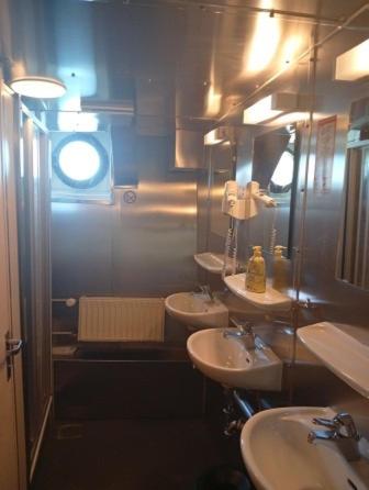 a bathroom with two sinks and a mirror at Schulschiff Deutschland Bremerhaven in Bremerhaven