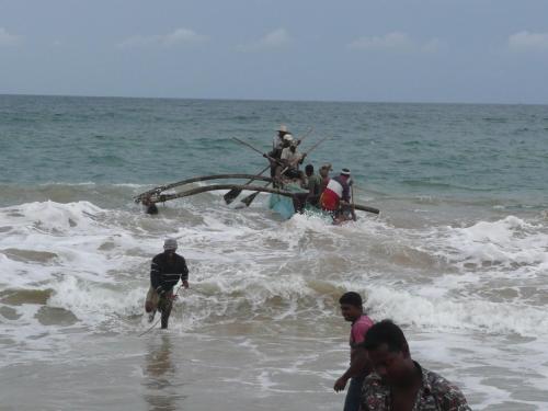 a group of people on a boat in the ocean at Czech House in Tangalle