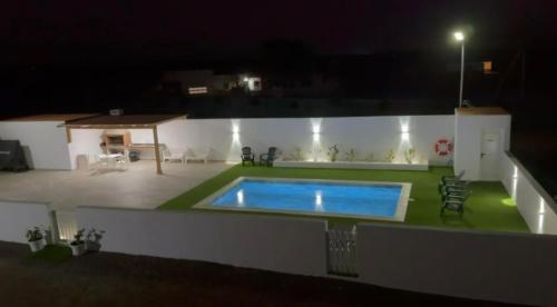 a swimming pool on the back of a house at night at Fuerte Roche 2 in Tuineje