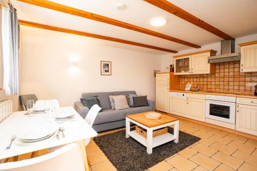 a living room with a couch and a table at Alte Scheune Koserow bei Baltic Home in Koserow