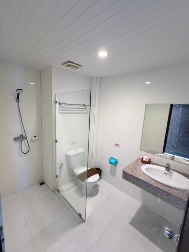 a bathroom with a shower and a toilet and a sink at MM Hill Koh Samui Hotel - SHA Certified in Chaweng