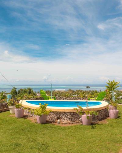 a swimming pool in a yard with potted plants at Raiatea Bellevue in Uturoa