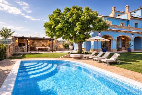 a swimming pool in front of a villa at La Masseria in Vasto