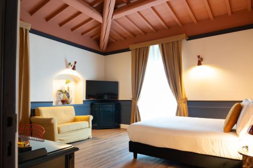 a bedroom with a bed and a couch and a chair at JOIVY Together Florence Secret Nest in Florence