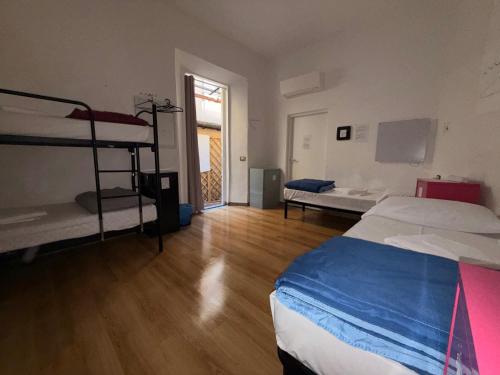 a room with two bunk beds and a wooden floor at My Friends in Florence