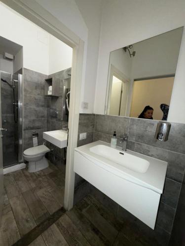a bathroom with a sink and a toilet and a mirror at My Friends in Florence
