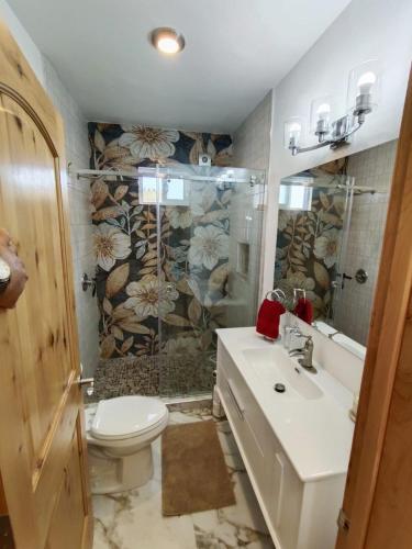 a bathroom with a sink and a toilet and a shower at Casa Mona MODERN Beach Home in Puerto Peñasco