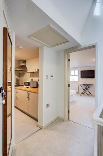 a kitchen with white walls and a white ceiling at Stylish 2BR Apartment in Leicester Square in London