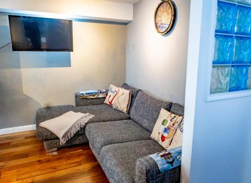 a living room with a couch and a flat screen tv at Lovely 2 Bedroom B-listed converted Whisky bond in Edinburgh