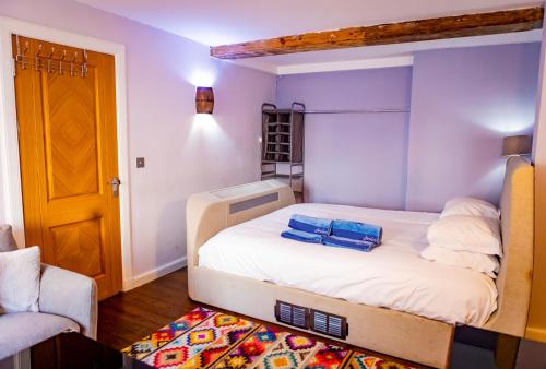 a bedroom with a large bed in a room at Lovely 2 Bedroom B-listed converted Whisky bond in Edinburgh