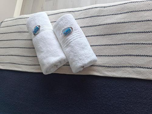 two towels sitting on top of a bed at SeeSkattie in St. Helena Bay