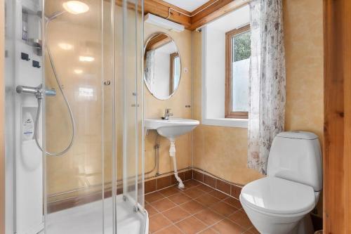 a bathroom with a toilet and a sink and a shower at Apartment close to the mountain in Svolvær