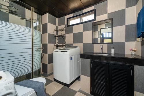 a bathroom with a toilet and a sink at Rawai Escape 5BR Pool Villa Close to Everything in Ban Saiyuan (1)