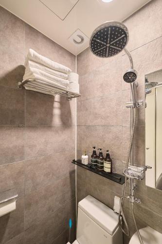 a bathroom with a shower and a toilet at Artravel Myeongdong in Seoul