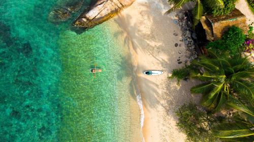 an overhead view of a beach with boats in the water at Pinnacle Koh Tao Resort in Ko Tao