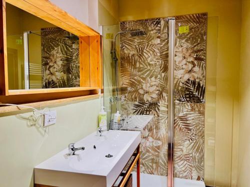 a bathroom with two sinks and a shower at Primiero Suite 3 downtown, garden in Transacqua