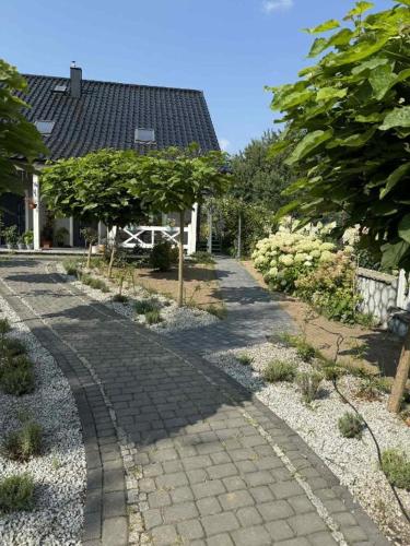 a cobblestone walk way in front of a house at Apartament Premium Pola in Bolesławiec