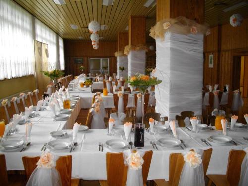 ポドグジンにあるDom wczasowy Lubuszaninの白いテーブルと椅子が備わる大きな宴会場