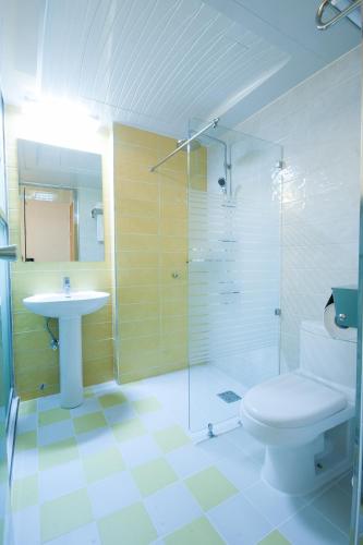 a bathroom with a shower and a toilet and a sink at Uniqstay in Busan