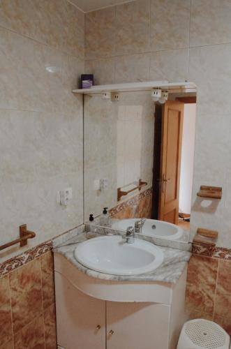 a bathroom with a sink and a tub at La ventanuca del Valle in Bielva