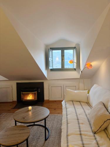 a living room with a couch and a fireplace at La ventanuca del Valle in Bielva