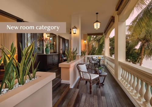 a lobby of a new room cafeteria with plants at Anantara Hoi An Resort in Hoi An
