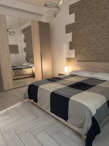 a bedroom with a large bed and a mirror at Eleven Home in Bari