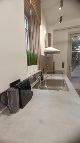 a kitchen with a sink and a counter top at Thermi Luxury apartments in Thermi